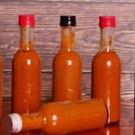 5 hot sauce bottles on a table
